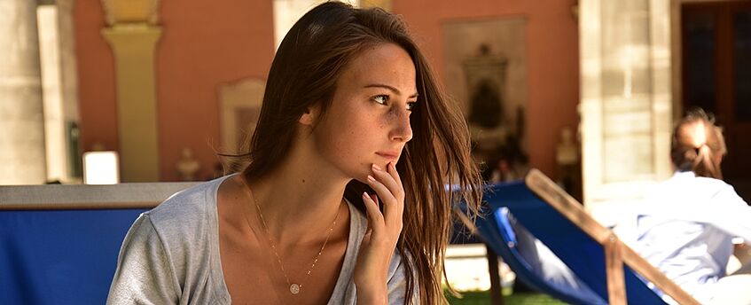 a person in the courtyard at the University's main building